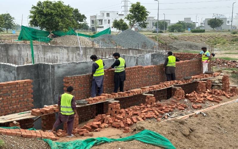 Construction engineers inspecting premium building materials for residential construction in Lahore